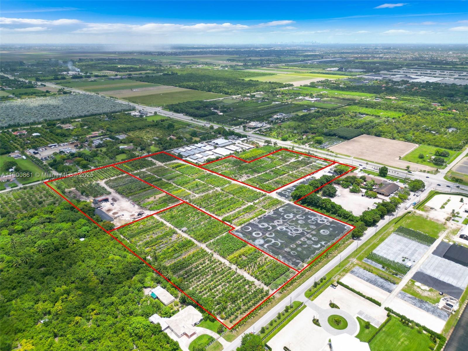 An aerial view shows a large agricultural property with rows of crops and greenhouses — 19000 SW KROME AKA 177 AVE, Miami FL 33187, MIAMI, FL