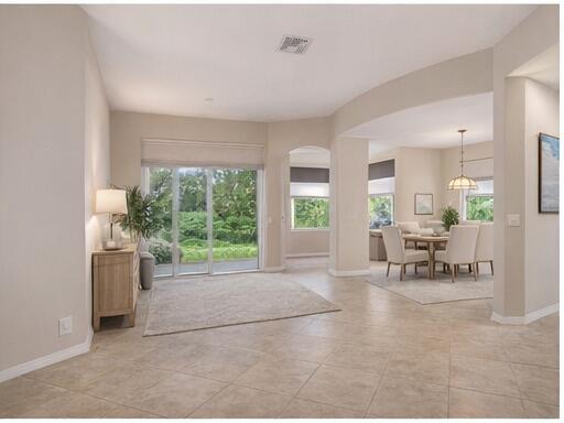 A bright living area with tile floors, a sliding glass door, and an adjacent dining room — 12636 Via Ravenna, Boynton Beach FL 33436, BOYNTON BEACH, FL