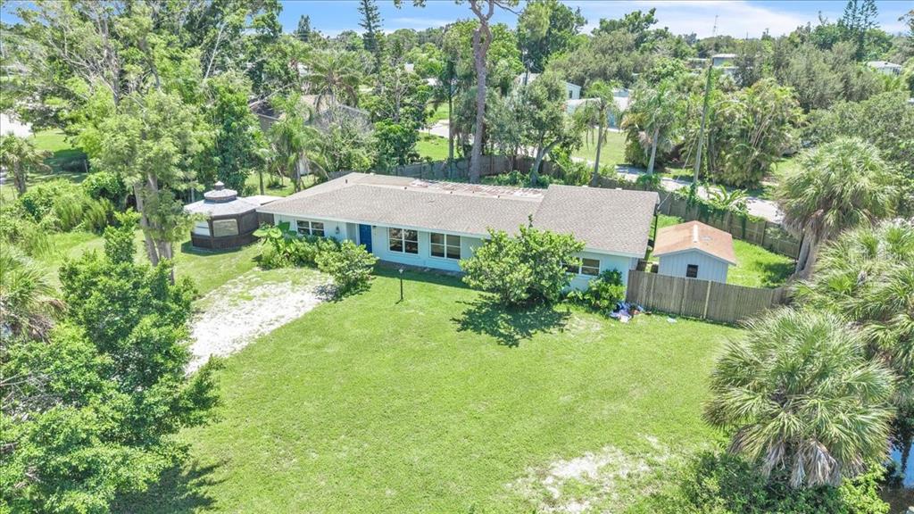 An aerial view of a single-story house with a gazebo and shed in a yard — 807 LUCILLE AVENUE, NOKOMIS, FL