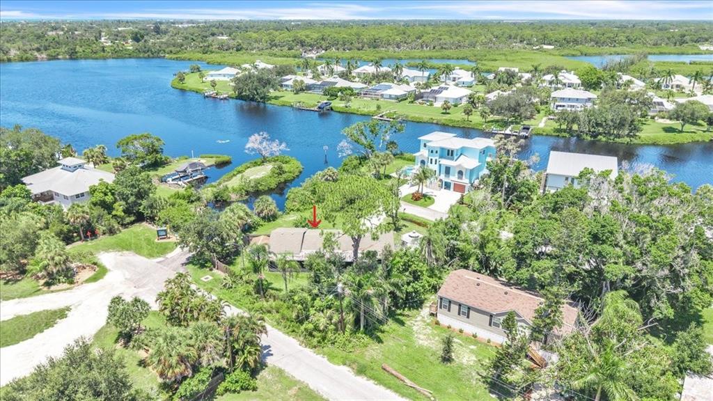 An aerial view of a house with a red arrow pointing to its roof — 807 LUCILLE AVENUE, NOKOMIS, FL