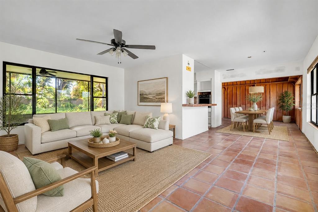 A living room with a sectional sofa, tile floors, and an adjacent dining area — 807 LUCILLE AVENUE, NOKOMIS, FL