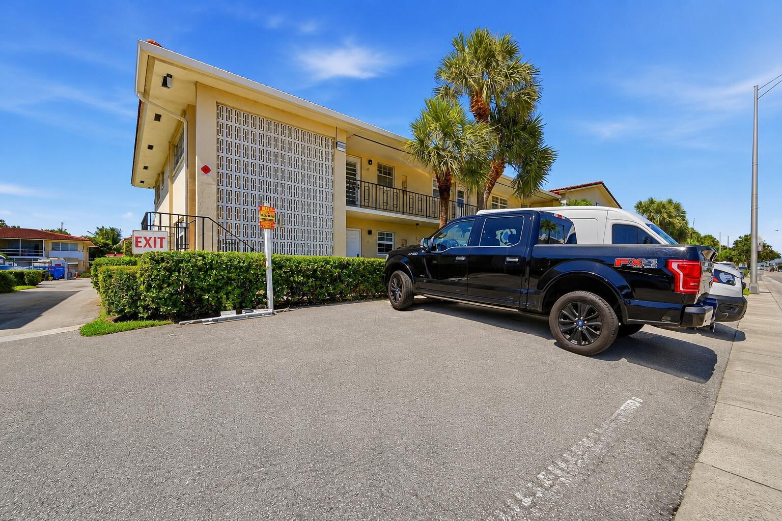 A black pickup truck is parked in front of a two-story apartment building — 2160 NE 36th Street # 37, Lighthouse Point FL 33064, LIGHTHOUSE POINT, FL