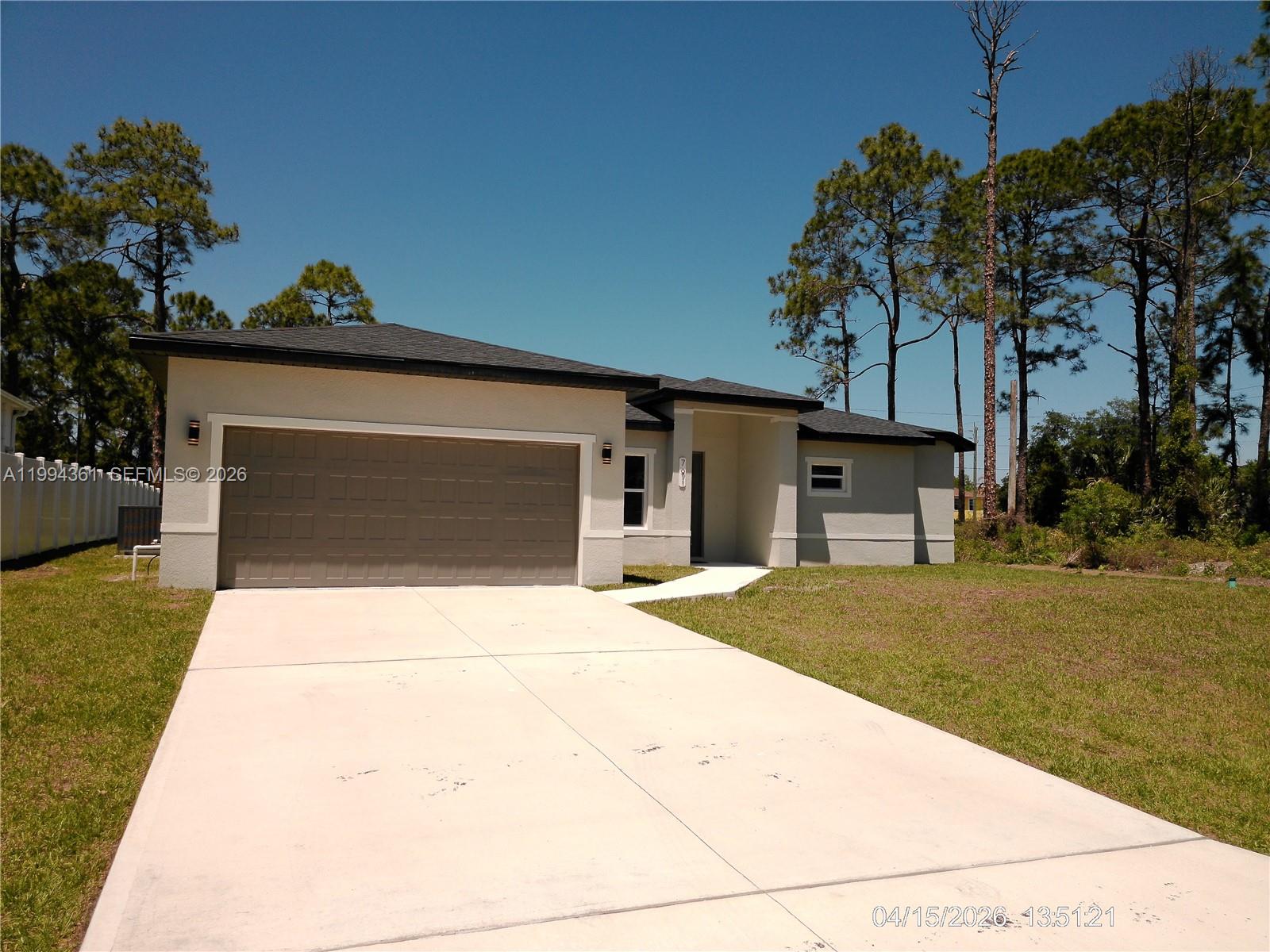 A single-story house with a light-colored stucco exterior, a garage, and a concrete walkway — 791 Reading ST SW, Palm Bay FL 32909, PALM BAY, FL