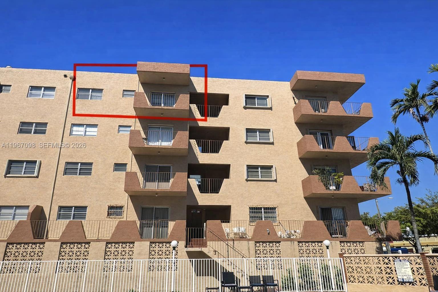 An exterior view of a multi-story apartment building with balconies and a red box highlight — 1630 W 46th St # 514B, Hialeah FL 33012, HIALEAH, FL