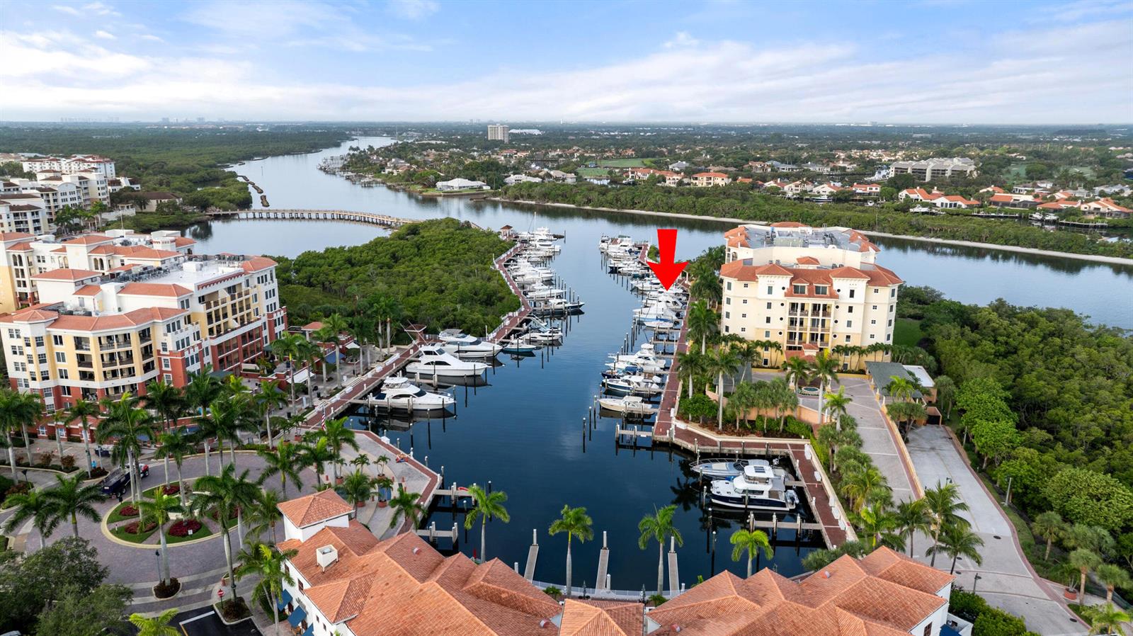 An aerial view shows a marina with docked boats between two large residential buildings — 348 S Us Hwy 1, 17, Jupiter FL 33477, JUPITER, FL