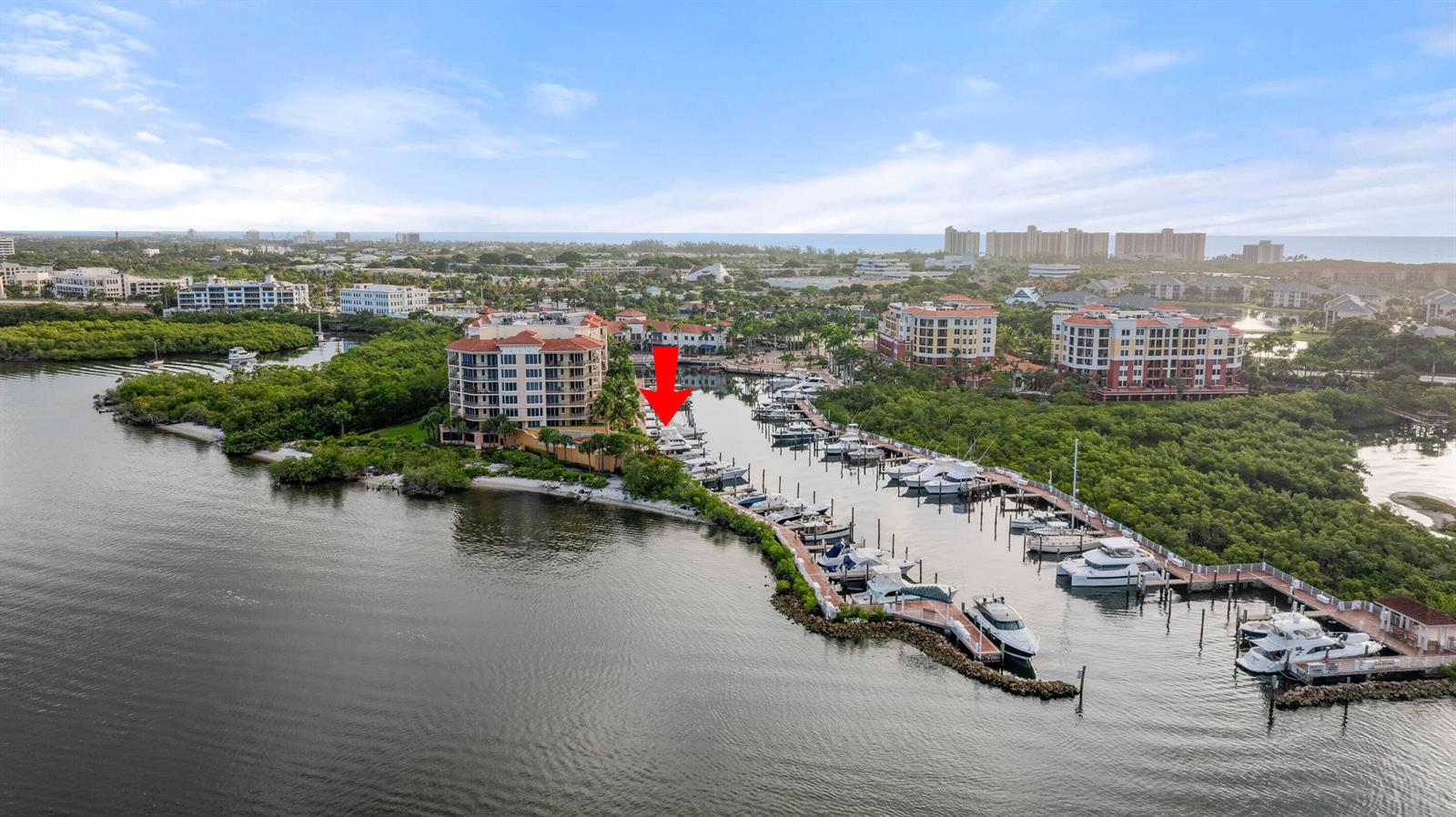 An aerial view shows a marina with docked boats next to a large residential building — 348 S Us Hwy 1, 17, Jupiter FL 33477, JUPITER, FL