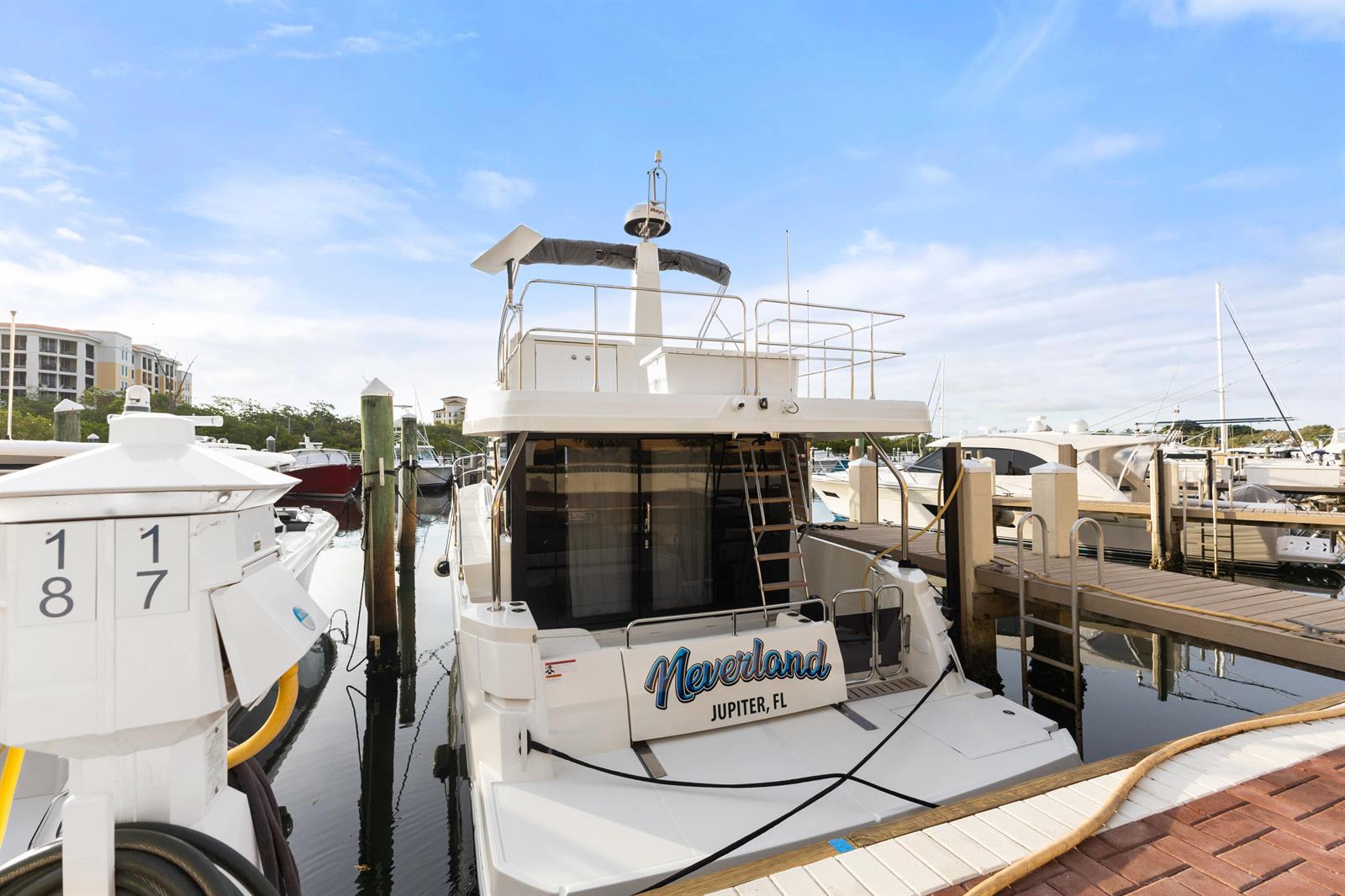 A white yacht named Neverland is docked at a marina under a blue sky — 348 S Us Hwy 1, 17, Jupiter FL 33477, JUPITER, FL
