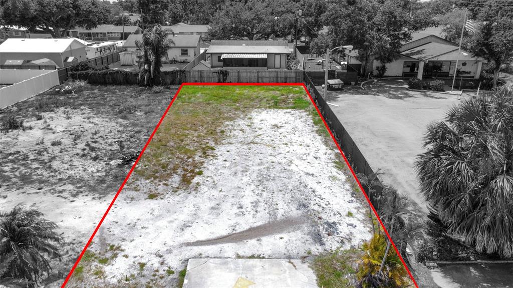 An aerial view shows a rectangular, vacant lot outlined in red between two properties — 35TH STREET W, BRADENTON, FL