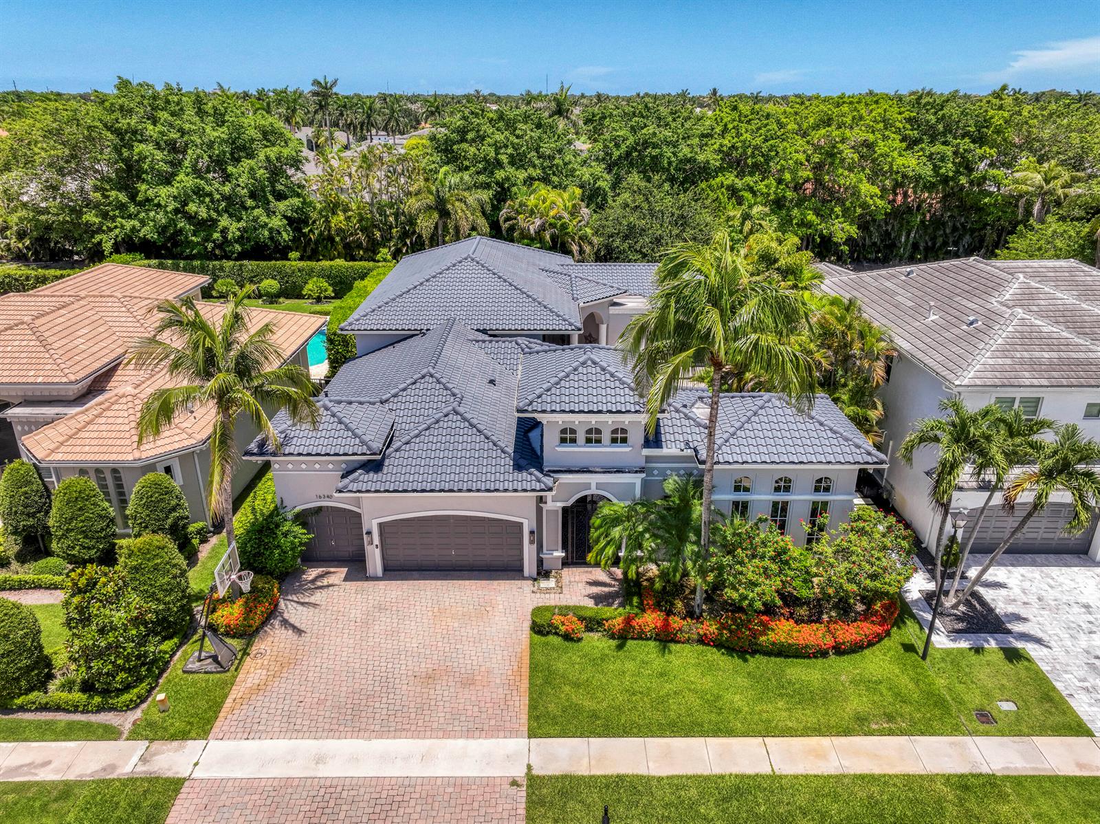 An aerial view of a two-story house with a gray tile roof and brick driveway — 16340 Via Venetia E, Delray Beach FL 33484, DELRAY BEACH, FL