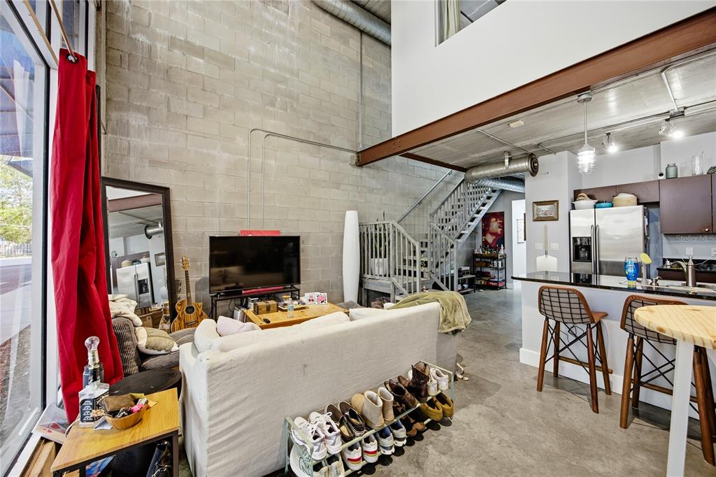 A three-story modern office building with glass windows and a gray exterior in a parking lot — 2515 SW 35TH PLACE UNIT 117, GAINESVILLE, FL