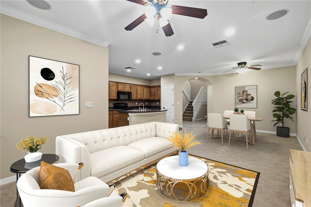 A living room with a white sofa, round coffee table, and an open kitchen area — 7212 STERLING POINT COURT, GIBSONTON, FL
