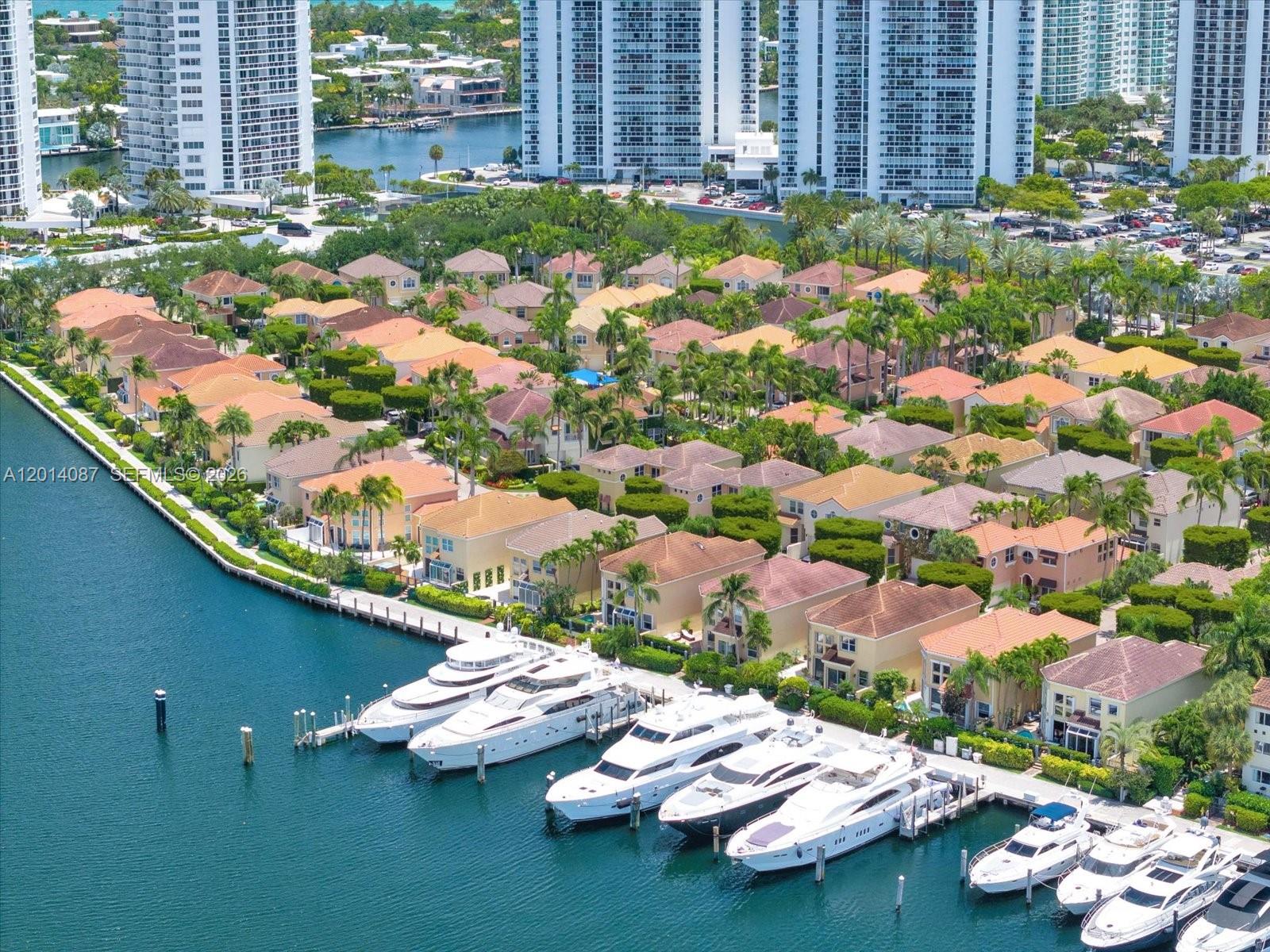 An aerial view shows a row of yachts docked along a canal beside residential houses — 3728 NE 208th Ter, Aventura FL 33180, AVENTURA, FL