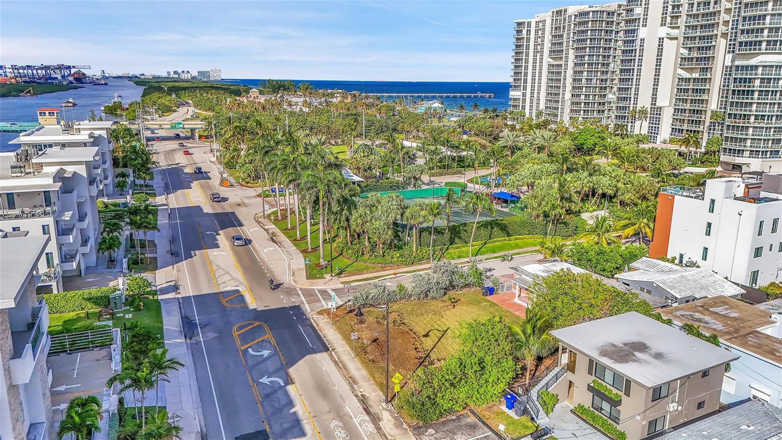 An aerial view shows a coastal road, palm trees, a tennis court, and high-rise buildings — 356 Balboa Street, Hollywood FL 33019, HOLLYWOOD, FL