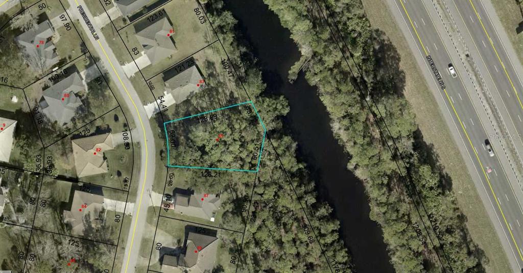 This is an aerial map showing a vacant residential lot highlighted in blue — 85 PRESIDENTIAL LANE, PALM COAST, FL