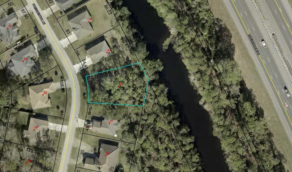 This is a satellite map showing a vacant residential lot outlined in blue — 85 PRESIDENTIAL LANE, PALM COAST, FL