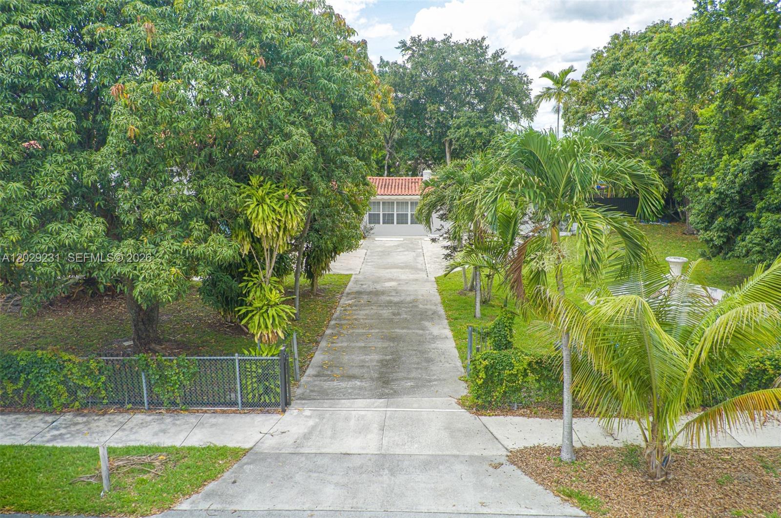 A long concrete driveway leads to a house with a red tile roof — 5613 Pierce St # 1, Hollywood FL 33021, HOLLYWOOD, FL