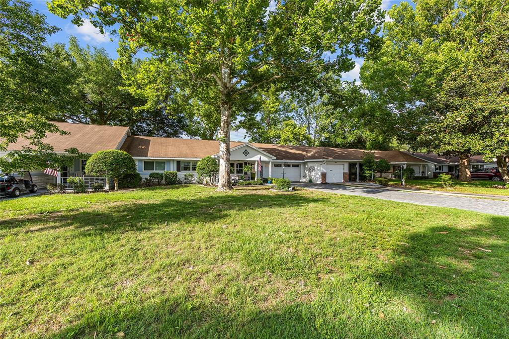 A single-story house with a brown roof, white siding, and a large front lawn — 8900 SW 97TH LANE ROAD UNIT H, OCALA, FL