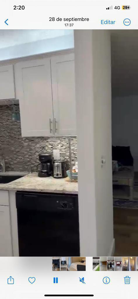 A kitchen features white cabinets, a granite countertop, a black dishwasher, and a tiled backsplash — 86 Crooked Tree Lane # 102, Vero Beach FL 32962, VERO BEACH, FL