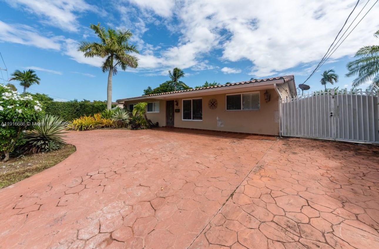A single-story house with a stamped concrete driveway and a white metal gate — 10260 SW 48th St, Miami FL 33165, MIAMI, FL