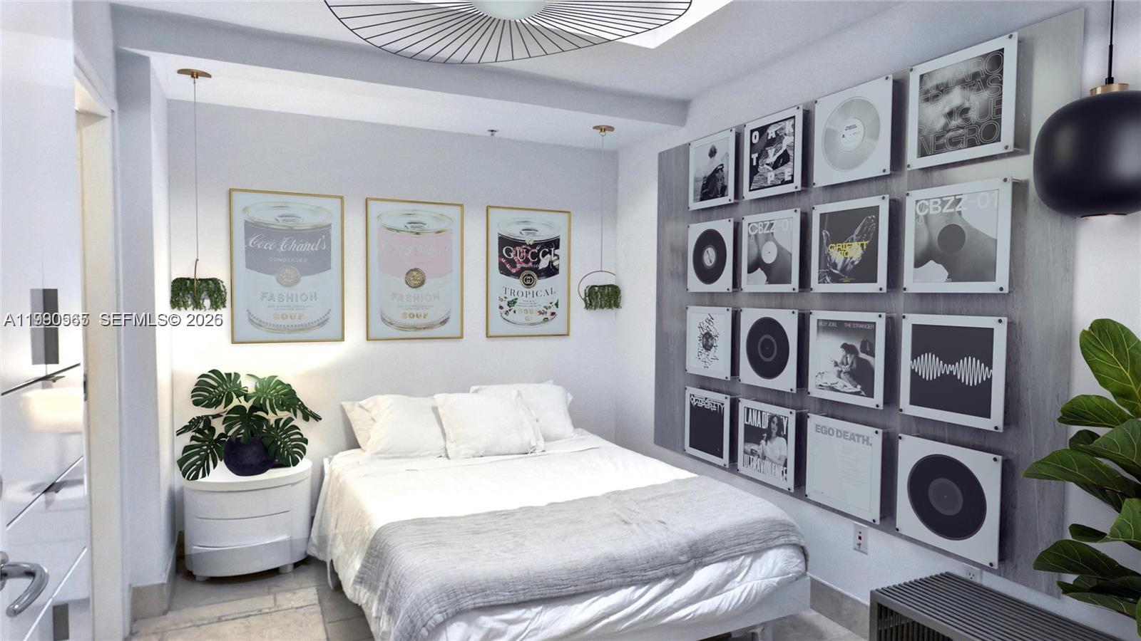 A bedroom features a bed, wall-mounted vinyl records, and framed art prints on white walls — 50 S Pointe Dr # 504, Miami Beach FL 33139, MIAMI BEACH, FL