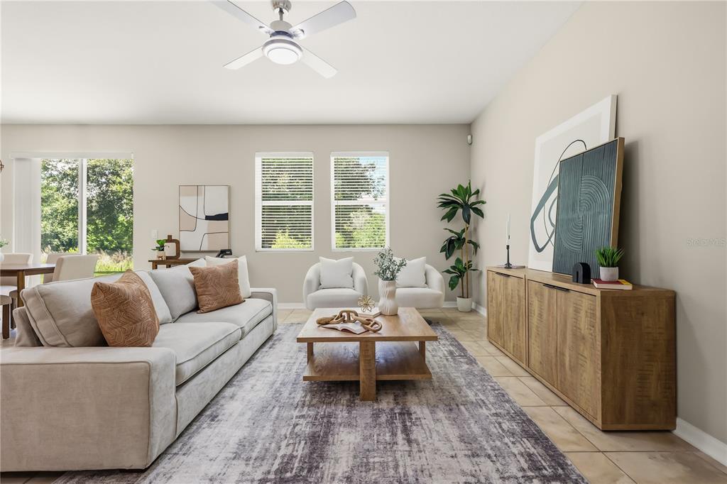 A living room features a light gray sofa, wooden coffee table, and a wooden media console — 215 LAKESHORE DRIVE, DAVENPORT, FL