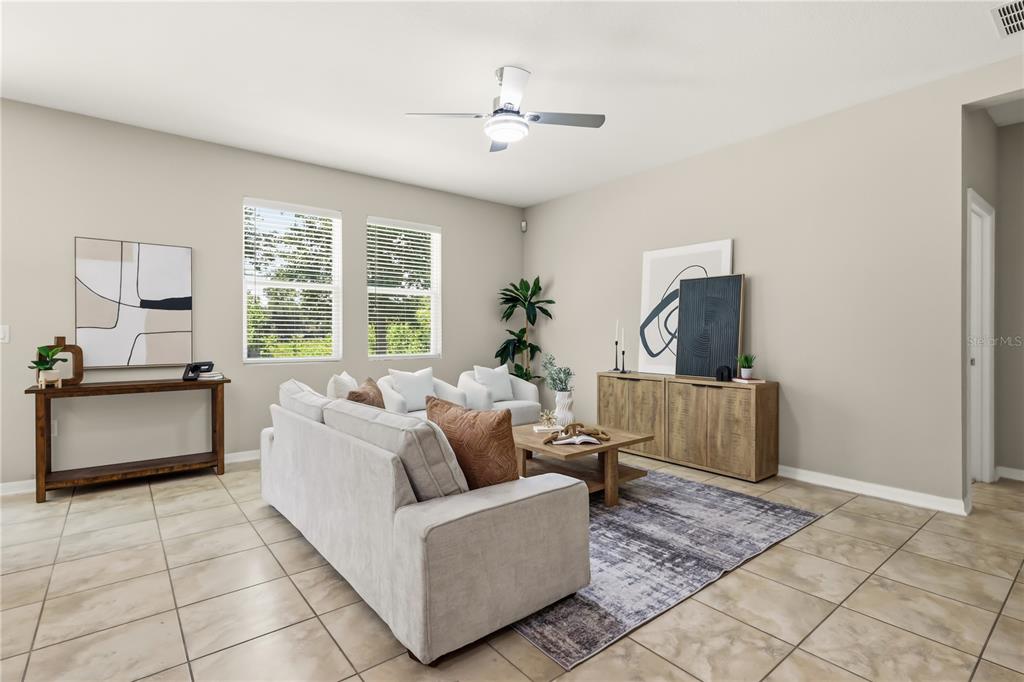 A living room features light tile floors, a neutral sofa, and a wooden console table — 215 LAKESHORE DRIVE, DAVENPORT, FL