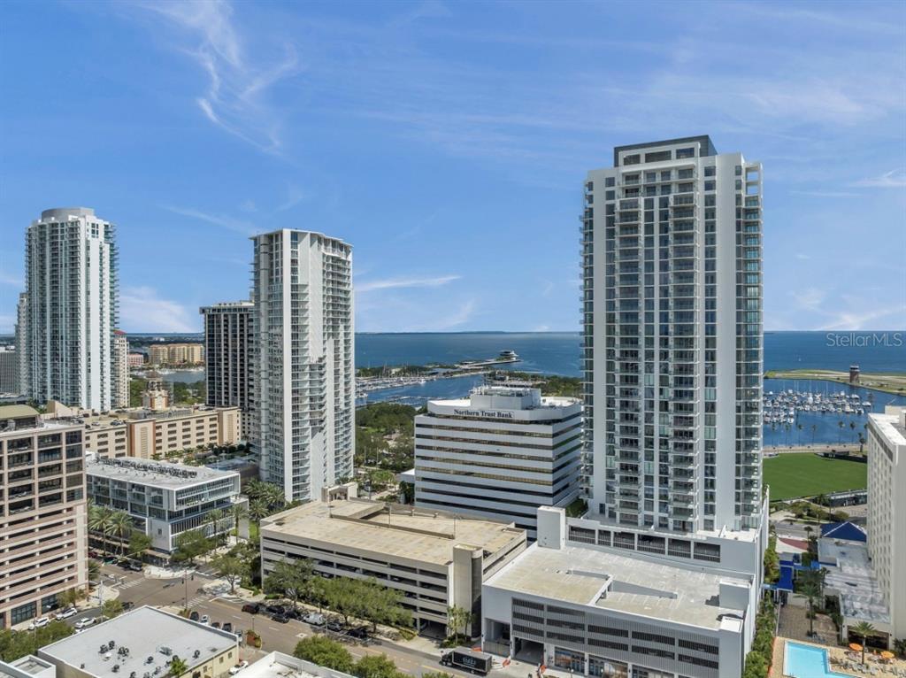 An aerial view of a city skyline featuring high-rise residential towers near a marina — 301 1ST STREET S UNIT 1704, ST PETERSBURG, FL