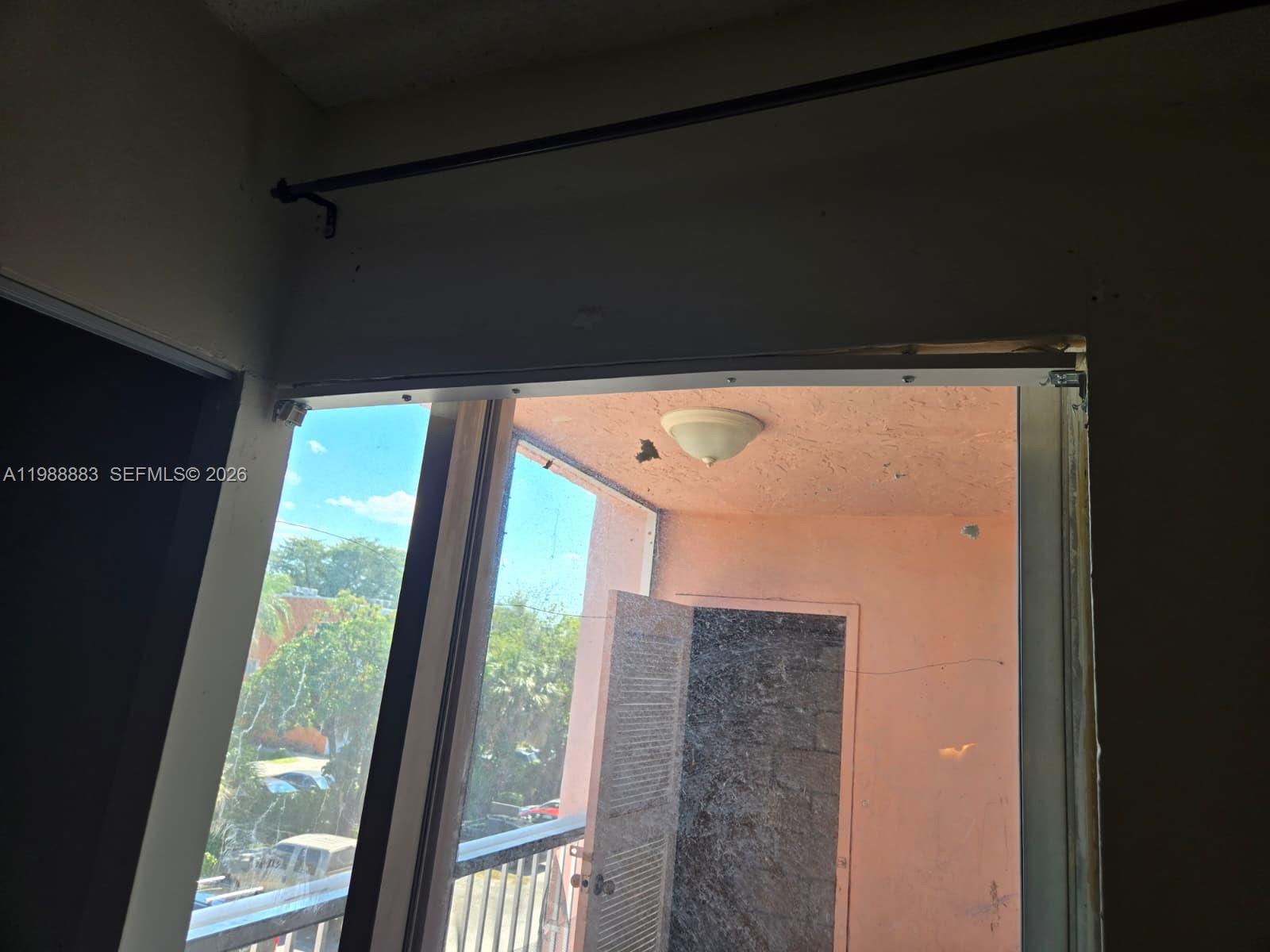 A view from an interior room looking out through a sliding door onto a balcony — 19791 SW 114th Ave # 335, Miami FL 33157, MIAMI, FL