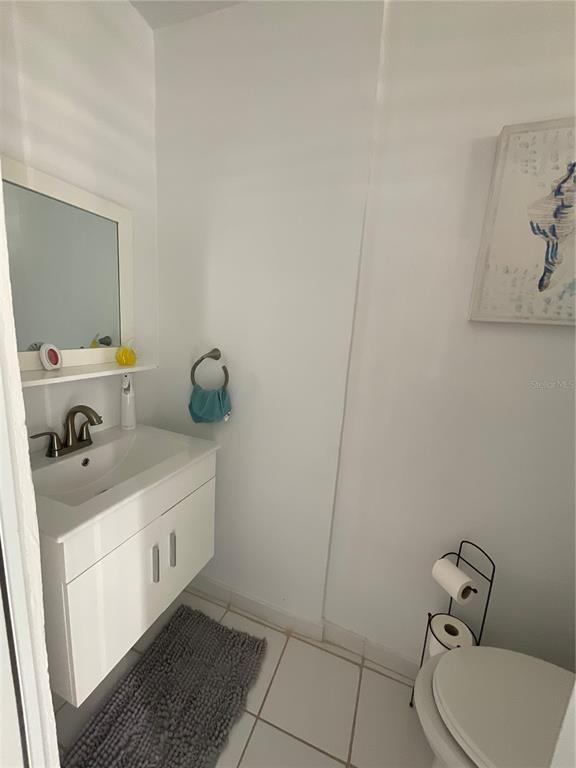 A small bathroom features a white floating vanity, a mirror, and a toilet — Villa Marina Village APT 5 B, FAJARDO, PR