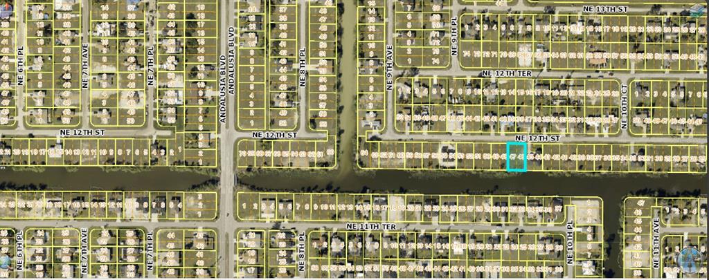 This is an aerial map showing a residential neighborhood with a highlighted plot of land — 934 NE 12TH STREET, CAPE CORAL, FL
