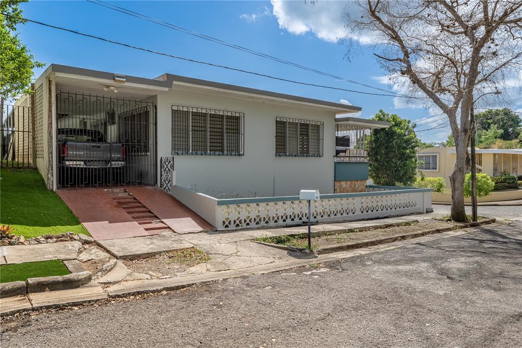A single-story house with a carport, security bars on windows, and a decorative concrete fence — 69 Urbanizacion Ramirez SAGRADO CORAZON ST UNIT 69, CABO ROJO, PR