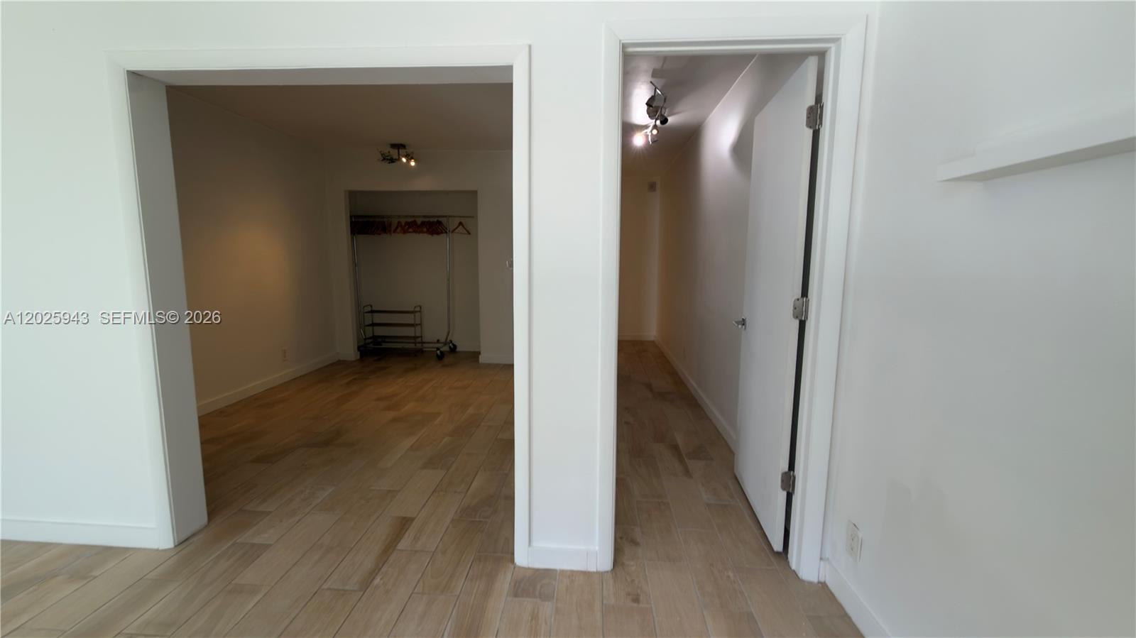 The image shows two adjacent doorways leading into a room with light wood-look flooring — MIAMI BEACH, FL