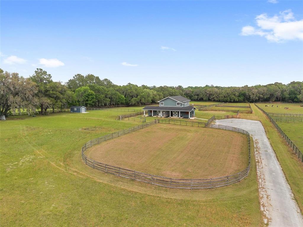 An aerial view shows a two-story house with a fenced pasture and a small shed — 16201 NW 162ND TERRACE, WILLISTON, FL