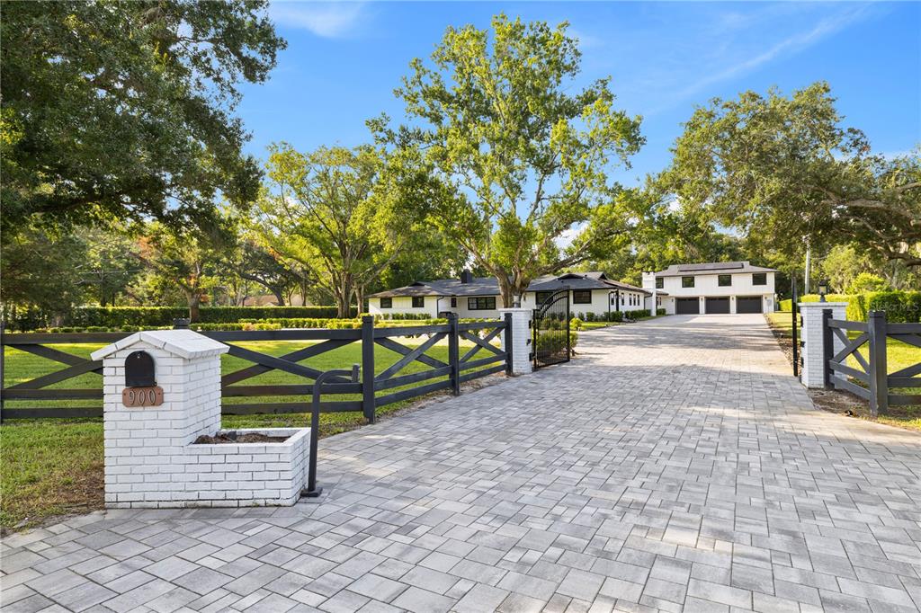 An aerial view shows a house with a swimming pool, basketball court, and large yard — 900 W PLANT STREET, WINTER GARDEN, FL