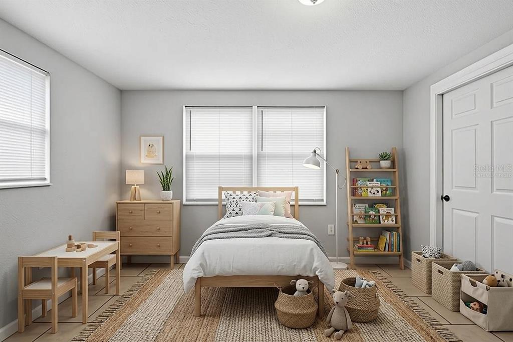 This virtually staged bedroom features a single bed, a wooden bookshelf, and a small table — 4506 POOLE STREET, NEW PORT RICHEY, FL