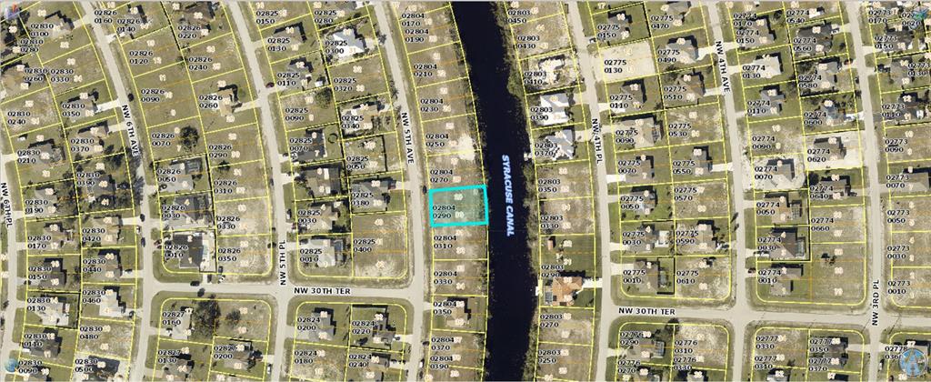 This is an aerial map view of a residential neighborhood with a highlighted vacant lot — 3061 NW 5TH AVENUE, CAPE CORAL, FL