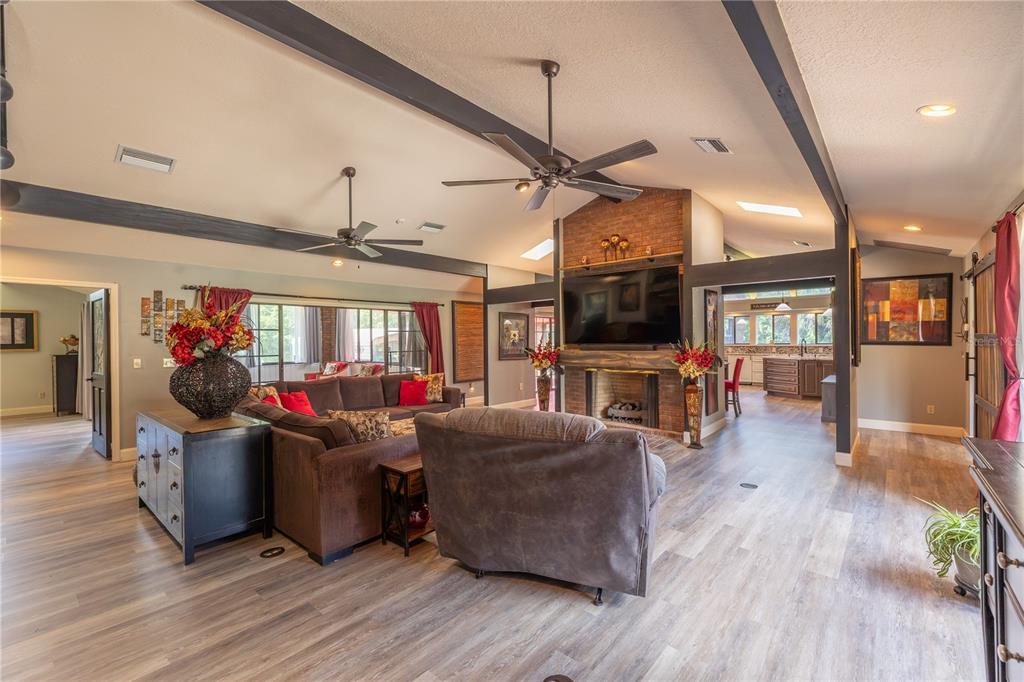 A hallway leads to a bathroom and a bar area with open shelving and wood paneling — 2550 SE 40TH STREET, OCALA, FL