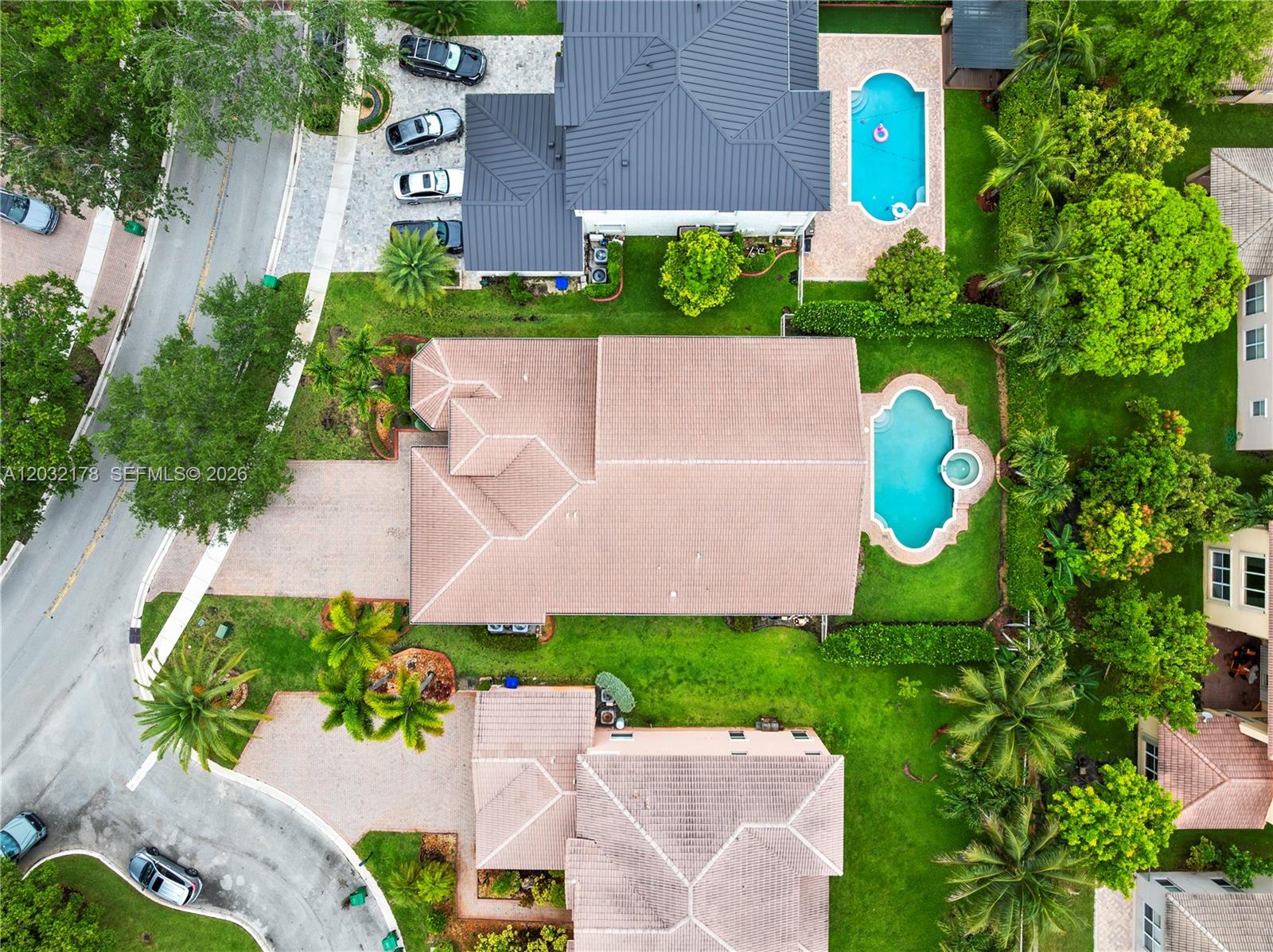 An aerial view shows several houses with swimming pools, paved driveways, and lush landscaping — 5431 SW 184th Way, Miramar FL 33029, MIRAMAR, FL