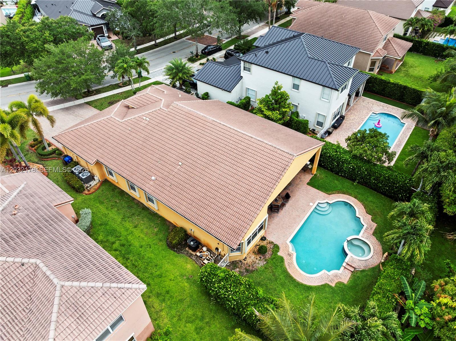 An aerial view shows a house with a tiled roof, a swimming pool, and landscaping — 5431 SW 184th Way, Miramar FL 33029, MIRAMAR, FL