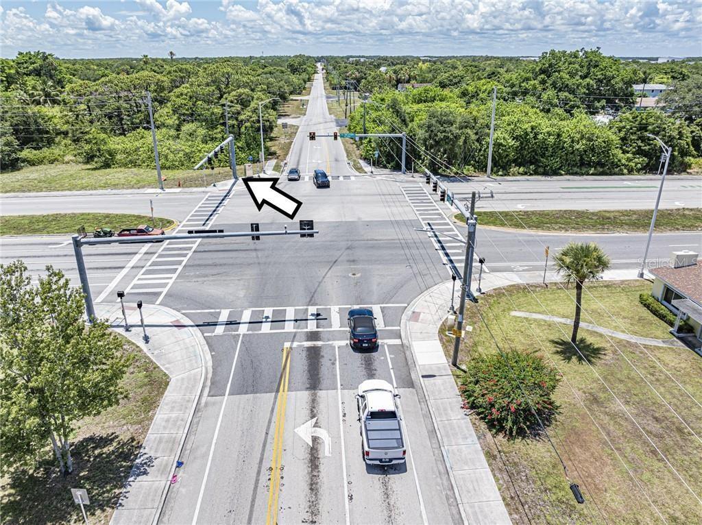 An aerial view of a paved intersection with traffic lights and vehicles on a sunny day — 2551 ST LUCIE BOULEVARD, FORT PIERCE, FL