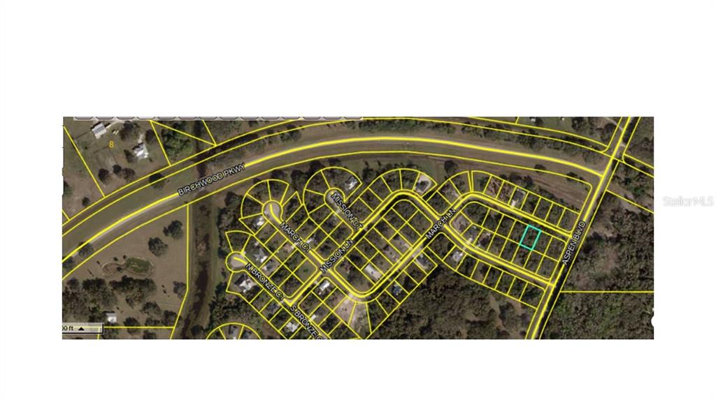 This is an aerial map showing a vacant residential lot highlighted in a subdivision — MARCH LANE, LABELLE, FL