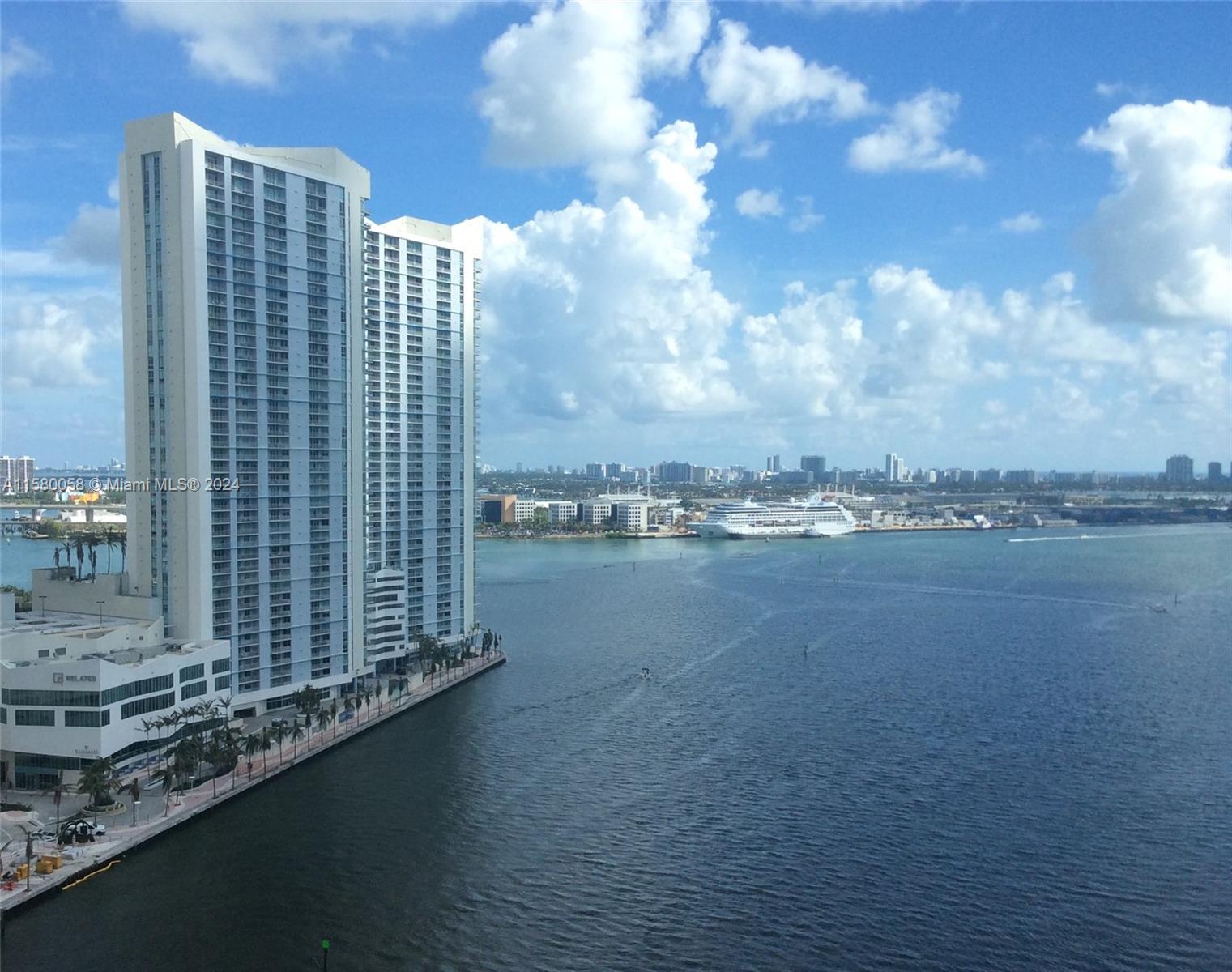 A high-angle view shows tall residential towers along a waterfront with a cruise ship nearby — 325 NE Biscayne Blvd # 1923, Miami FL 33131, MIAMI, FL