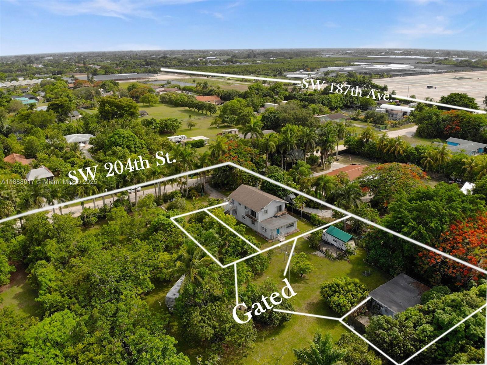 An aerial view shows a two-story house on a large, tree-filled lot with gated access — 18475 SW 204th St, Miami FL 33187, MIAMI, FL