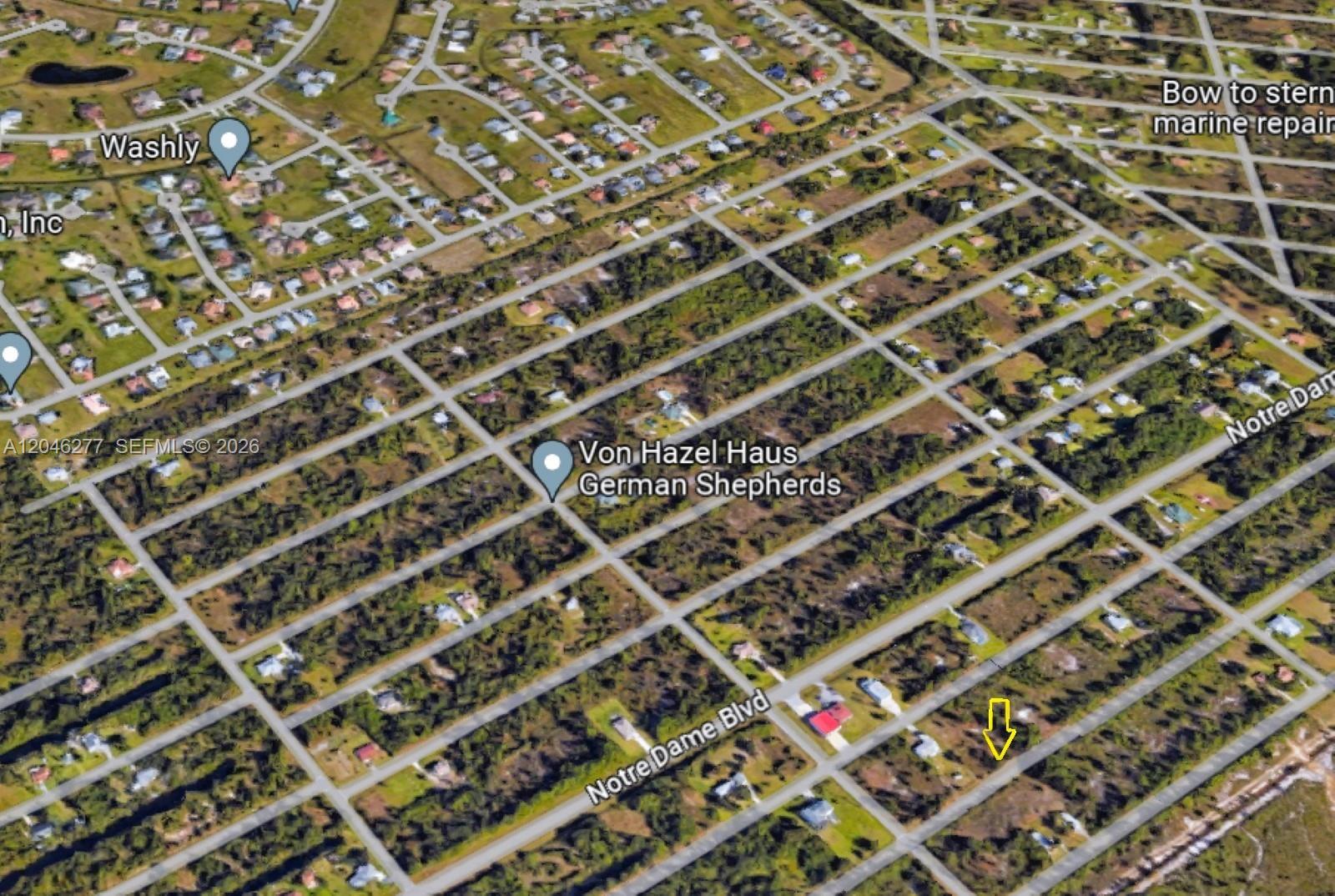 This is an aerial map view showing a residential area with a yellow arrow pointing down — 26318 Hapsburg Rd, Punta Gorda FL 33955, PUNTA GORDA, FL