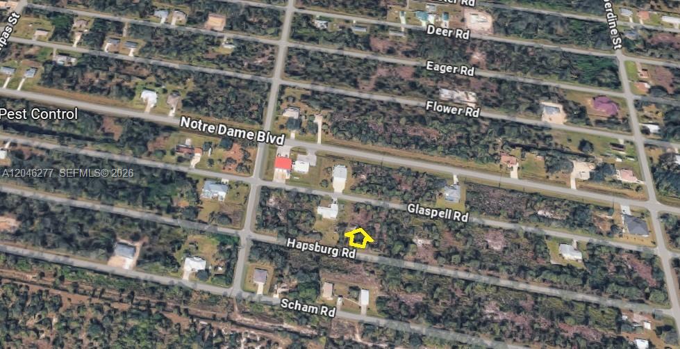 This is an aerial map view showing a vacant lot marked with a yellow outline — 26318 Hapsburg Rd, Punta Gorda FL 33955, PUNTA GORDA, FL