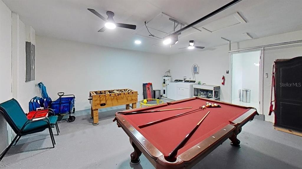 A garage converted into a game room with a pool table and foosball table — 251 SE 46TH STREET, CAPE CORAL, FL