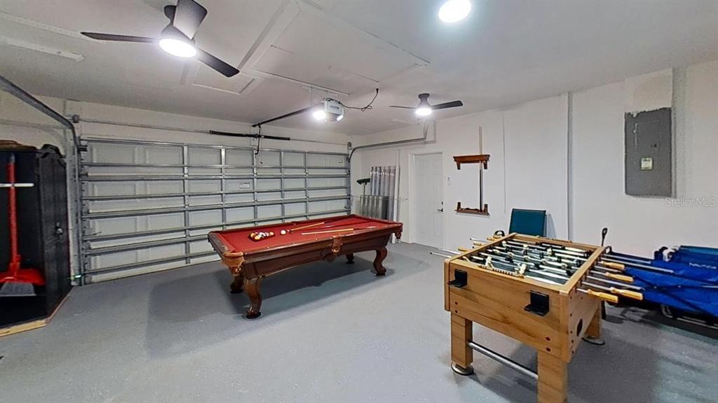 A garage converted into a game room featuring a pool table and a foosball table — 251 SE 46TH STREET, CAPE CORAL, FL