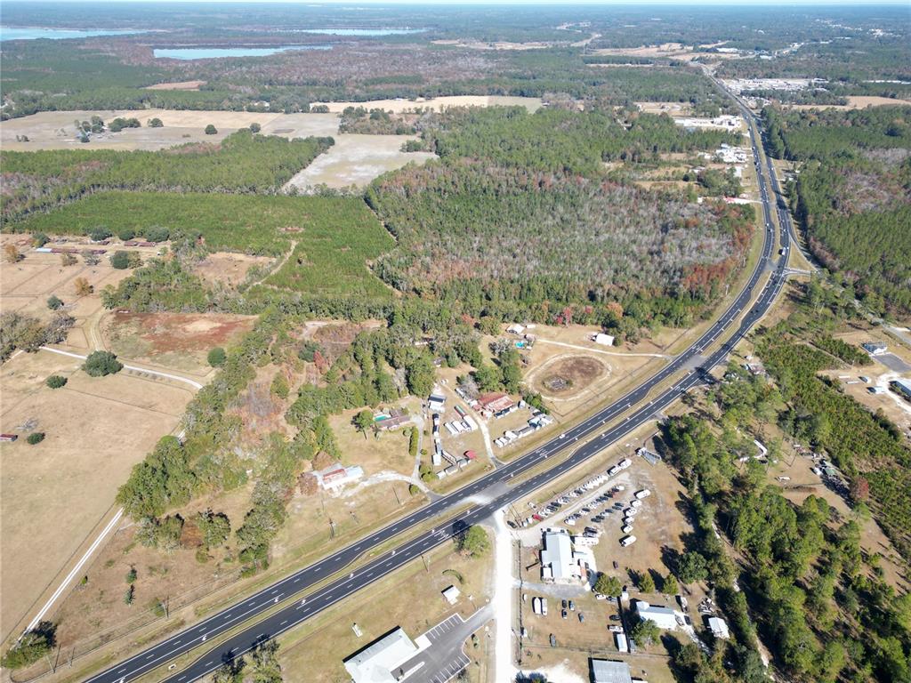 An aerial view shows a highway running through a rural area with scattered buildings — 11782 SW 59TH AVENUE, STARKE, FL