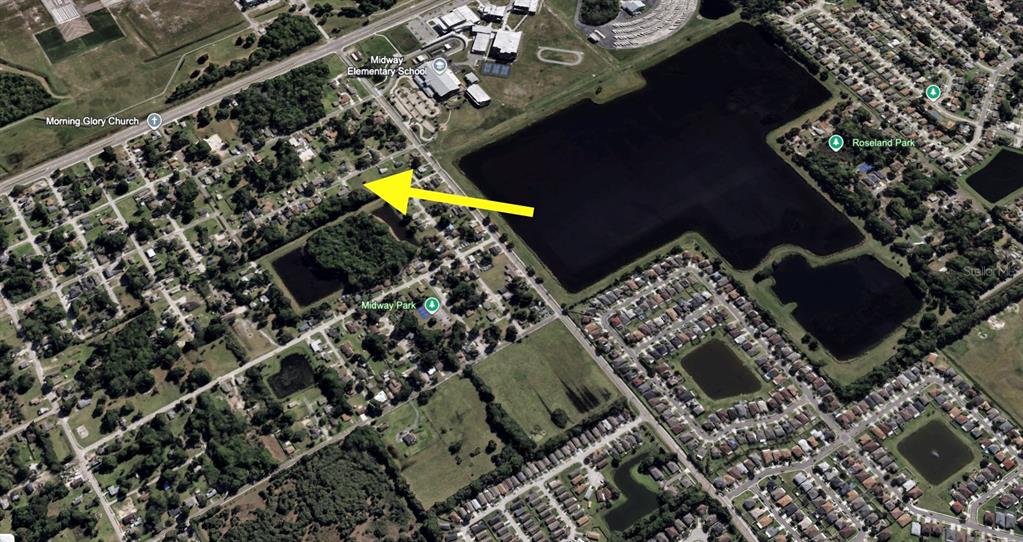 An aerial map view showing a residential neighborhood with a yellow arrow pointing to a property — CRAWFORD DRIVE, SANFORD, FL