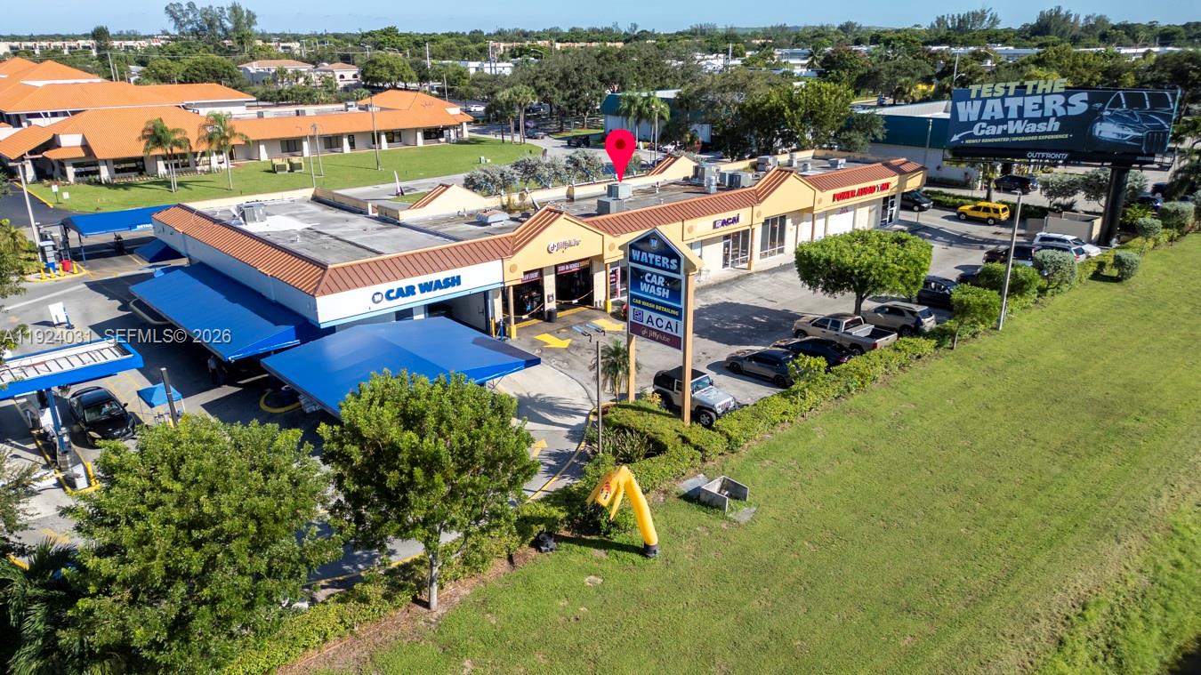 An aerial view shows a commercial car wash facility with a parking lot and signage — 23133 Sandalfoot Plaza Dr, Boca Raton FL 33428, BOCA RATON, FL